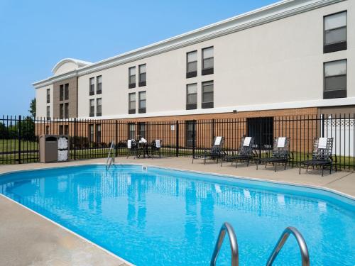 a swimming pool in front of a building at Holiday Inn Express Indianapolis Airport by IHG in Plainfield