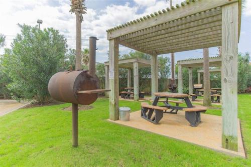 a picnic area with a grill and a picnic table at GypSEA Blu Beach Condo Steps to the Beach in Galveston