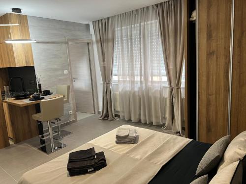 a bedroom with a bed and a desk and a computer at MISIC HOME in Colmar