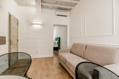 a living room with a couch and a glass table at APT ROME - Vittoria Palace in Rome