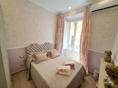 een slaapkamer met een groot bed en een raam bij Suite della Vite 27 in Rome