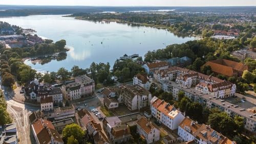 an aerial view of a city and a river at Ostróda City Center PKO lake apartments balcony in Ostróda