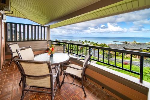 a balcony with a table and chairs and a view of the ocean at Kapalua Villas Maui - Select Your Unit in Kahana