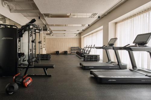 a gym with several treadmills and cardio machines at Rydges Melbourne in Melbourne