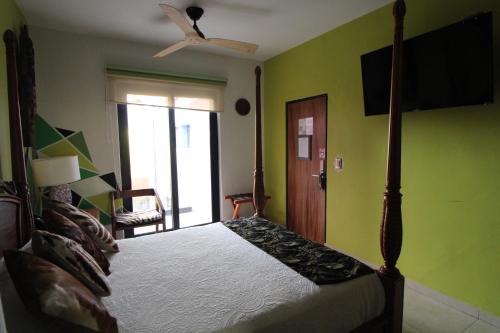 a bedroom with a bed and a ceiling fan at Ekléctic Hotel Boutique in Guadalajara