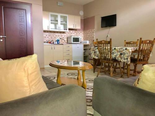 a living room with a table and a kitchen at Struga-Rooms/Dhoma/Sobi in Struga