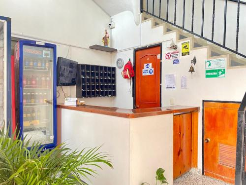 a drink station in a building with a staircase at Ayenda Alfay Mosquera in Mosquera