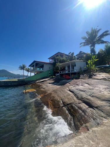 a house on the shore of the water at Cabana Do Mar in Angra dos Reis