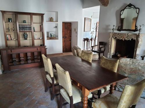 een eetkamer met een houten tafel en stoelen bij Charming apartment in medieval tower in Spoleto