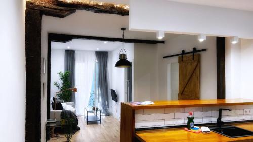 a kitchen with a counter and a living room at Bilbao Ronda apartamento con balcón Casco Viejo in Bilbao