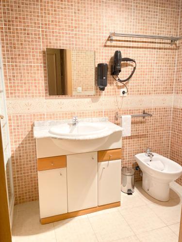 a bathroom with a sink and a toilet at Naturaleza En Soldeu - Disfruta En Familia - Parking Gratis l by BonesVacances in Soldeu
