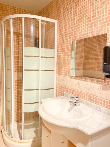 a bathroom with a sink and a shower at Naturaleza En Soldeu - Disfruta En Familia - Parking Gratis l by BonesVacances in Soldeu