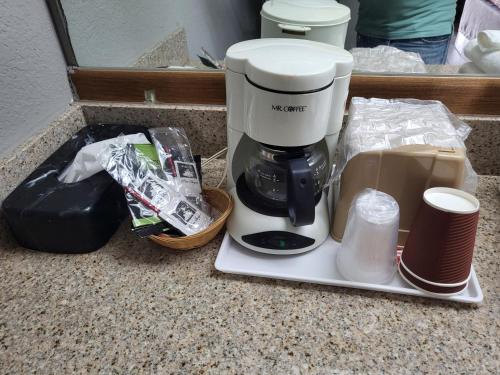 a coffee maker sitting on a counter next to a box at Econolodge in Andalusia