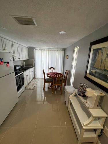a kitchen with a table and a dining room at Comfy 2 bedroom apartment in Port Richey