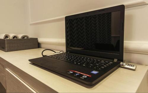 a laptop computer sitting on top of a desk at Hotel Lassa in Seoul
