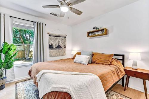 a bedroom with a large bed and a window at Savannah Place: Mid-Century Modern 3 Bedroom Home in Savannah