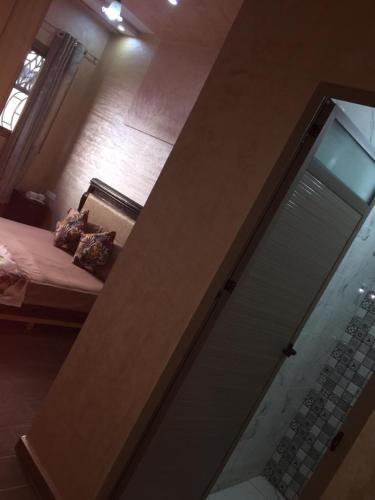 a glass door in a room with a bed at Sweet Room Airport 5 in Deroua
