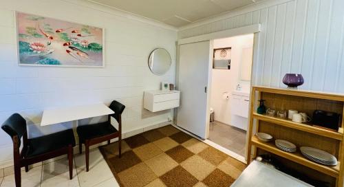 a small bathroom with a table and a sink at Greenfields in Fernmount
