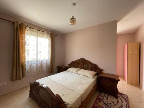 a bedroom with a bed and a window at B&B - Private rooms 2 in Tirana