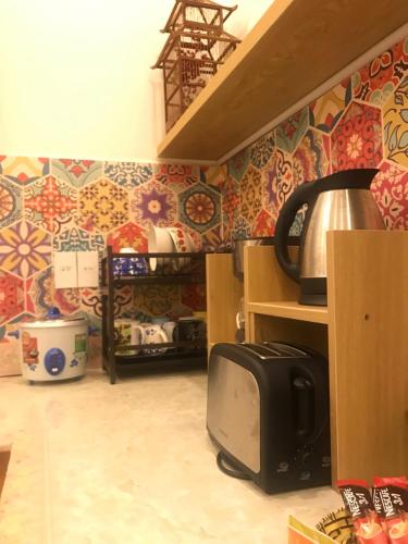a kitchen with colorful tiles on the wall at Whispering Pines Dalat (Thông Thì Thầm ĐL) in Da Lat