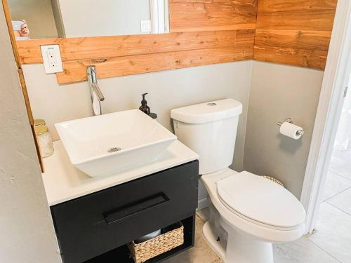 a bathroom with a white toilet and a sink at Surf Getaway, Queen Bed, Private Lanai in Keaau