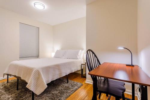 a bedroom with a bed and a desk and a table at Saratoga Serenity: Charming Rental Nearby Downtown in Saratoga Springs