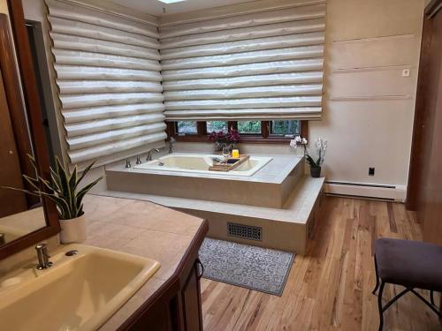 a large bathroom with a tub and a sink at Indoor pool, hot tub, sauna! in Colorado Springs