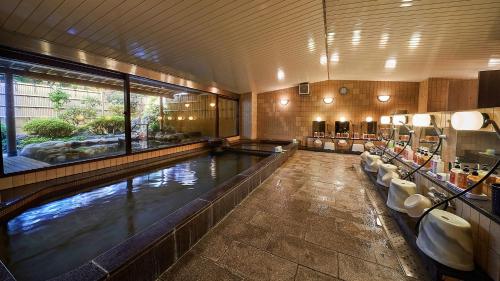 a large indoor swimming pool in a building at Diamond Arima Onsen Society in Kobe