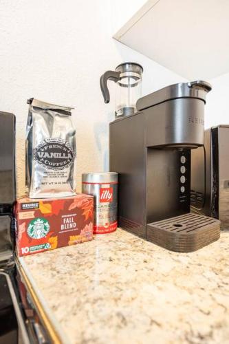 a kitchen counter with a coffee maker on a counter top at Lovely historic apt near Amelia Arena + Hyde Park in Tampa