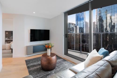 a living room with a couch and a large window at Imagine Marco in Melbourne