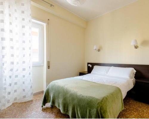a bedroom with a large bed and a window at Eco B&B Marela in Rome