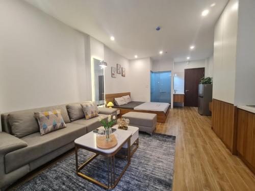 a living room with a couch and a table at The West Lake Serenity'N Homestay Ha Noi 462 in Hanoi