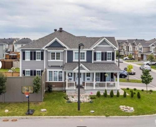 a house with a basketball hoop in the yard at Beautiful Unit in Nepean Ottawa in Ottawa