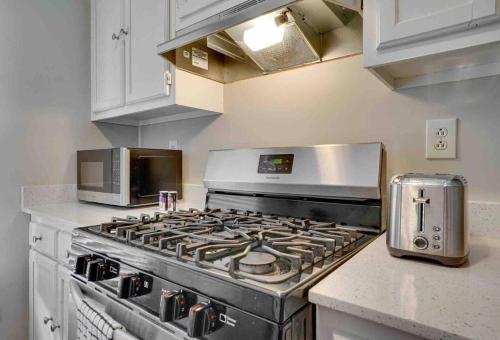 a kitchen with a stove and a microwave at Peace and Games with Class in Stone Mountain