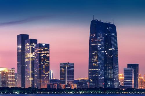 a city skyline at night with tall buildings at W Suzhou - Jinji Lake in Suzhou