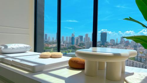 a bathroom with a white sink and a window at SkyPool with Seaview 8pax Beacon Executive Suites - Georgetown City Centre - 3km to Komtar in George Town