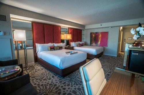 a hotel room with two beds and a television at Charming Unit at MGM Grand STRIP Las Vegas in Las Vegas