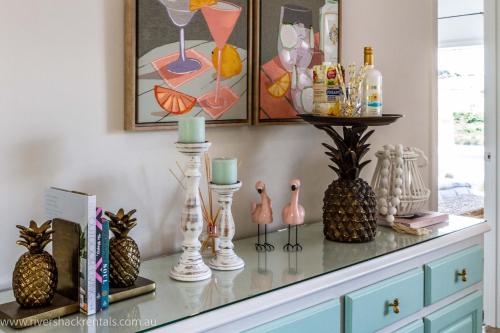 a dresser with vases and candles on top of it at Pina Colada Shack-40 Marina Way in Mannum