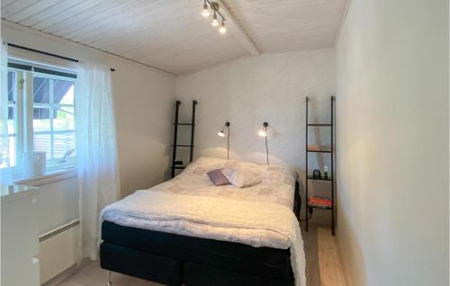 a bedroom with a bed in a room with a window at Gorgeous Home In Boxholm With House Sea View in Boxholm