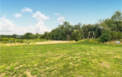 a field of grass with a fence and trees at Awesome Home In Zuidwolde With Sauna in Zuidwolde
