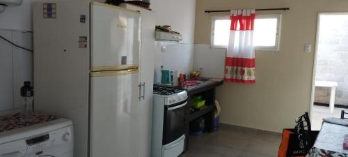 a kitchen with a white refrigerator and a stove at Casa Las Moras in La Rioja