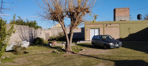 a car parked in a yard next to a tree at Casa Las Moras in La Rioja