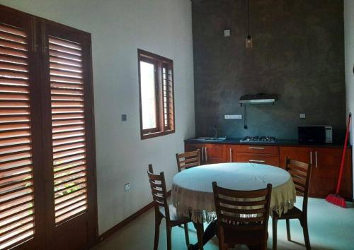 a dining room with a table and chairs and a kitchen at Fully Furnished house for rent in Gampaha/Ja-ela (Colombo) in Gampaha