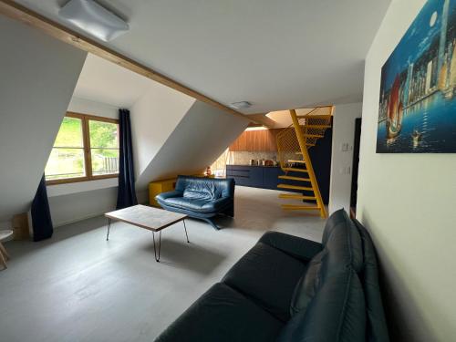 a living room with a couch and a table at MARYS family friendly Apartments,VISIT RHINE FALLS for FREE if you stay 2 nights, SOHO 95m2 2-Bedrooms 2nd floor & SOUTH BEACH 105m2 3-Bedrooms & LOFT 115m2 3-Bedrooms Suite with Galerie,LOFT Netz 20m2, Pinball, Schaffhausen-Hemmental, Rheinfall 10 km in Schaffhausen