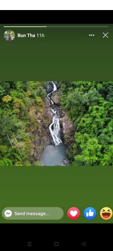 a screenshot of a video screen of a waterfall at Bee Bee's Chalets home stay and trekking in Banlung