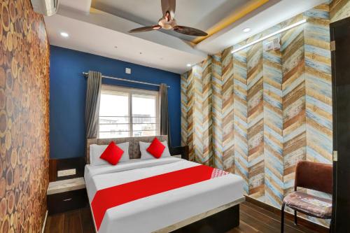 a bedroom with a bed and blue walls at OYO Flagship Hotel 7 Star in Udaipur