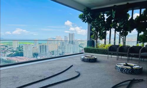 a balcony with chairs and a view of a city at SkyPool with Seaview 8pax Beacon Executive Suites - Georgetown City Centre - 3km to Komtar in George Town