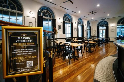 a restaurant with tables and chairs and a sign at The Chancellor on Currie in Adelaide