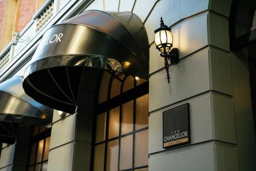 a street light attached to the side of a building at The Chancellor on Currie in Adelaide