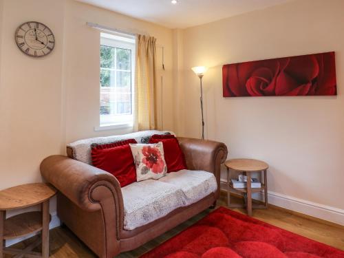 a living room with a couch and a window at Cupid's Cottage in Bessingby